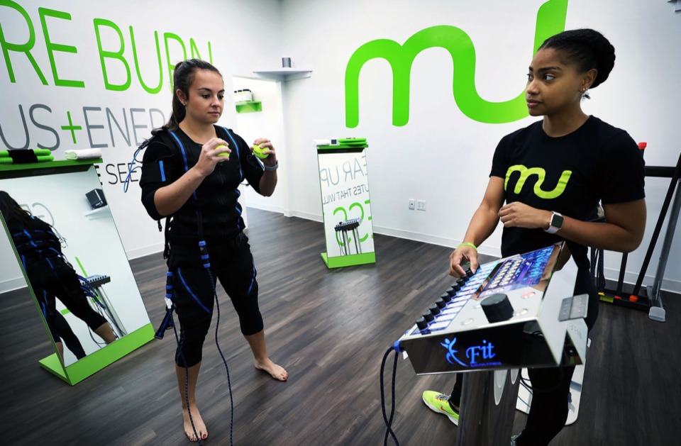 <strong>Trainer Amber Paxton leads an electrical stimulation workout with client Caroline Doherty at Manduu's 575 S. Perkins Rd. location Monday, Aug. 19.</strong> (Patrick Lantrip/Daily Memphian)