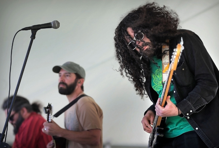 <strong>Bass player Andrew Gerazi (right) performs with Tony Manard and Show Goat during the first Mid-South Hemp Fest at Overton Park on April 20, 2019. With over 100 booths selling or promoting cannabis and hemp products, marijuana advocates gathered to listen to live music and enjoy a food truck rodeo in observance of 4/20, the counterculture holiday derived from "420" - insider shorthand for cannabis consumption.</strong> (Jim Weber/Daily Memphian)