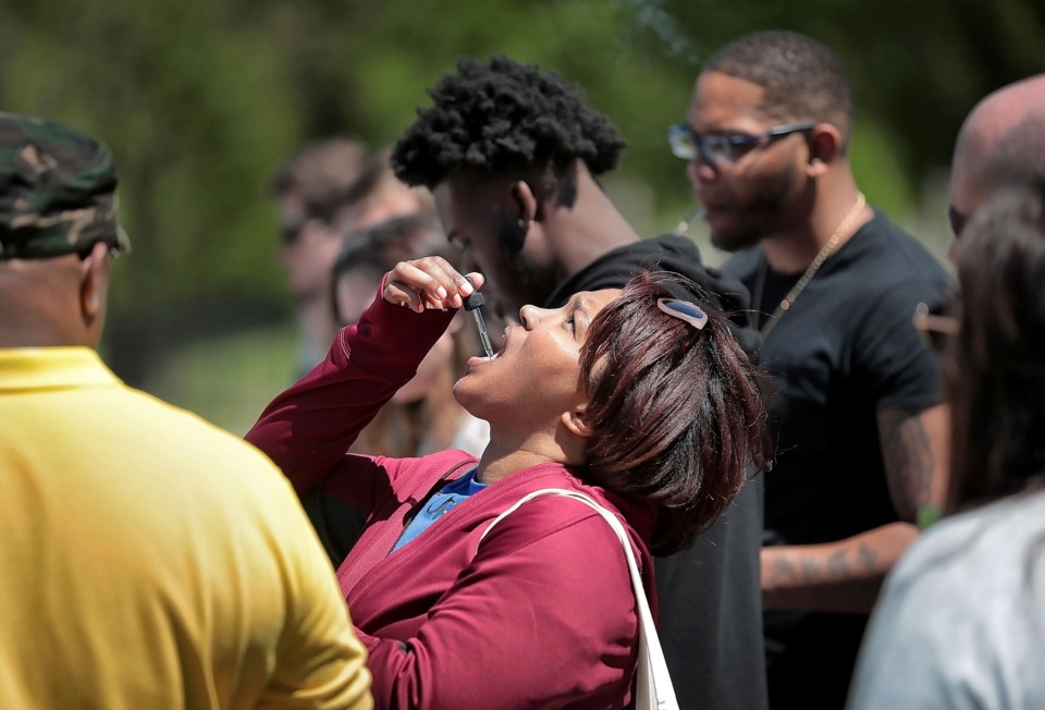 <strong>Iseashia Thomas samples CBD oil, a legal form of marijuana that she hopes will help cure her migraine headaches, during the first Mid-South Hemp Fest at Overton Park on April 20, 2019. </strong>(Jim Weber/Daily Memphian)