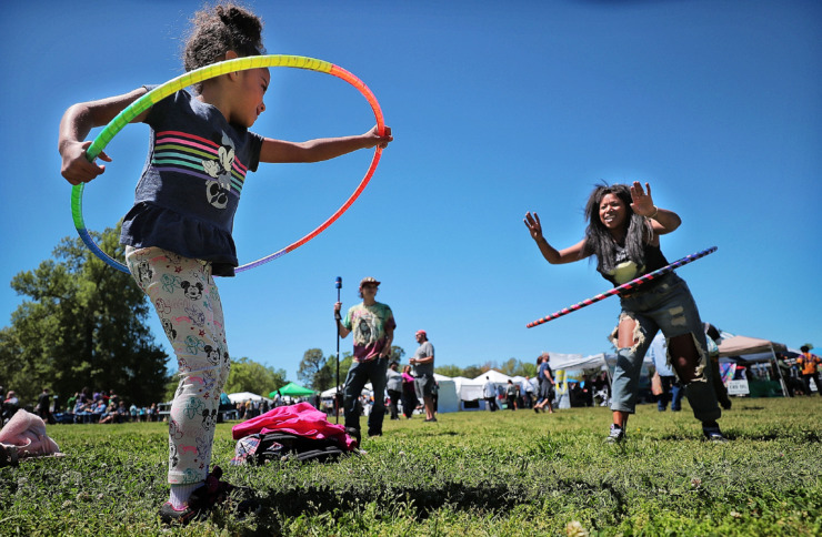 <strong>Ava Butterick, 4, takes a hula hoop lesson from her mother, Jessica Stevenson (right), during the first Mid-South Hemp Fest on April 20, 2019, at Overton Park.</strong> (Jim Weber/Daily Memphian)